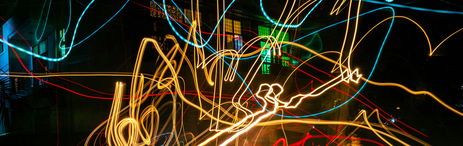 Chaotic streaks of colorful light swirling in the dark, suggesting noise and overwhelming information